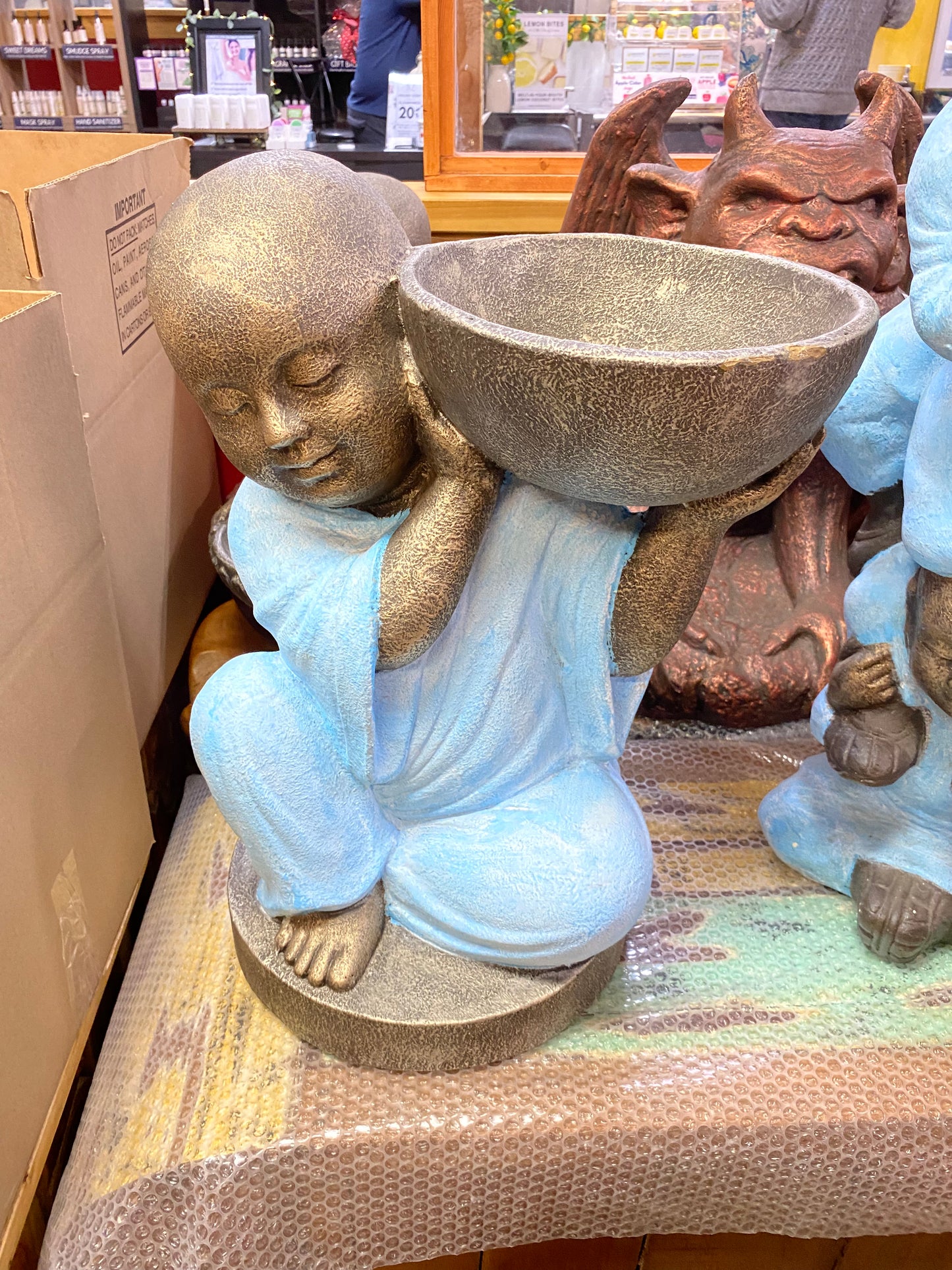 Monk with bowl on shoulder statue